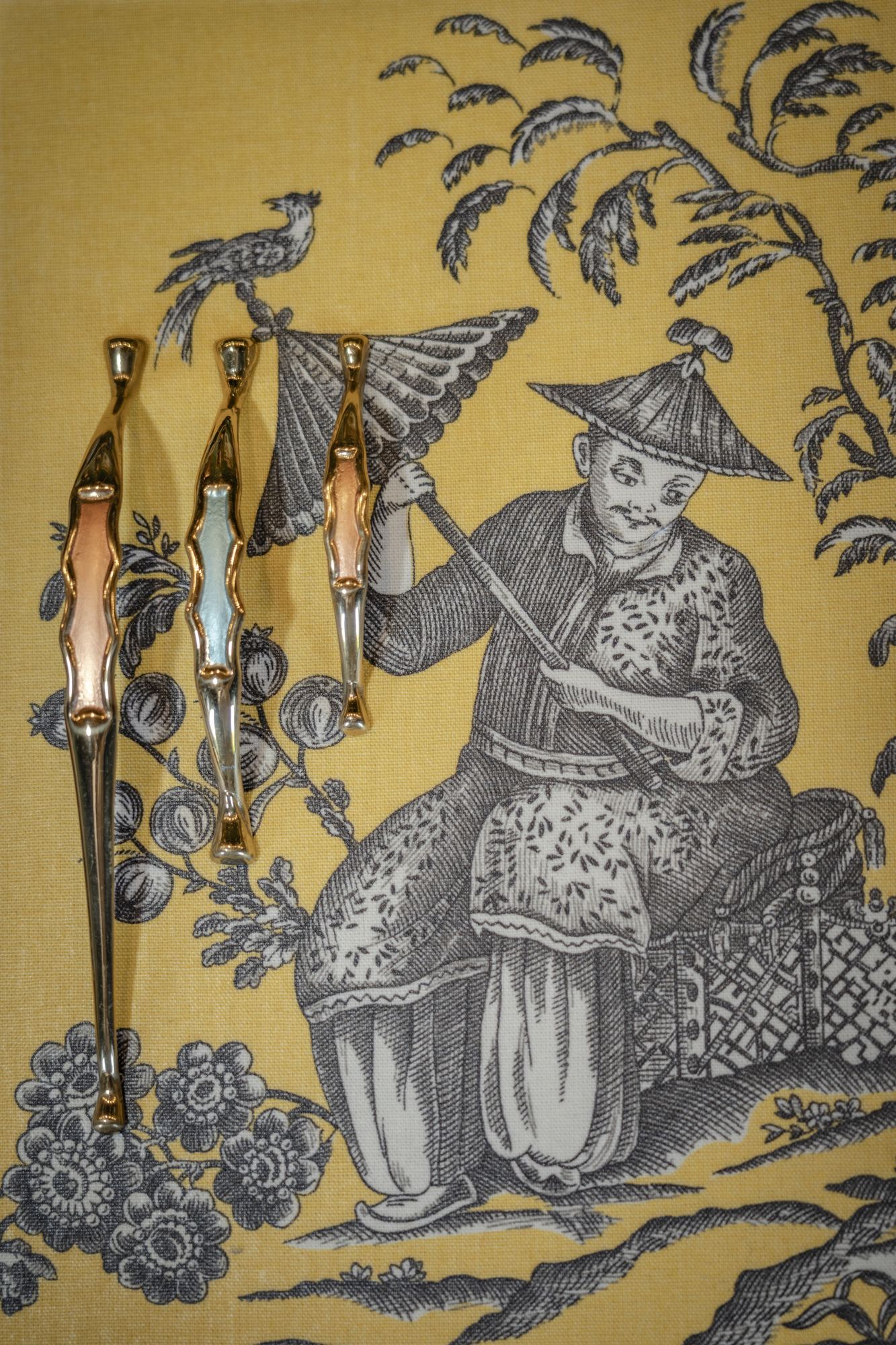 Yellow chinoiserie toile wallpaper with a figure under a parasol