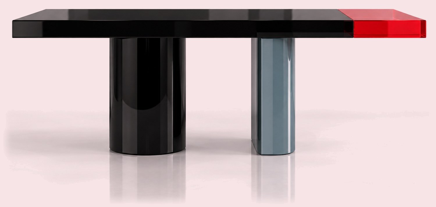 Black lacquered table with asymmetric black and blue-grey legs and a translucent red end